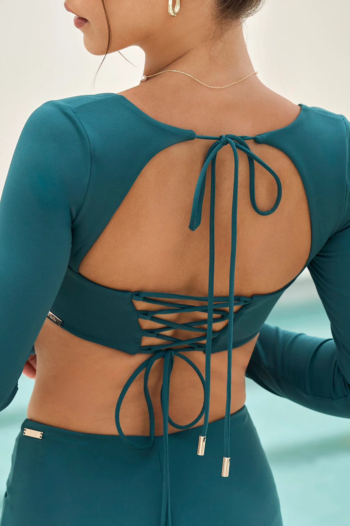 11003-tranquil-twist-long-sleeve-bikini-top-dark-sea-1.webp